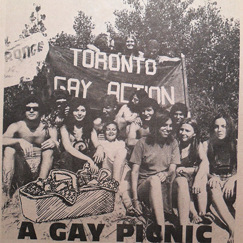 An old black and white photo of a group of people sitting on the ground together smiling. The picture reads at the bottom "A Gay Picnic".