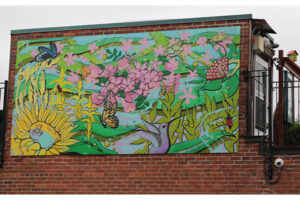 A picture of a mural featuring brightly coloured flowers and butterflies.
