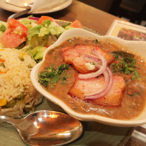 A Photo Of A Spread Of Food Including A Soup, Salad And Ball Of Fried Rice Set On A Plate.